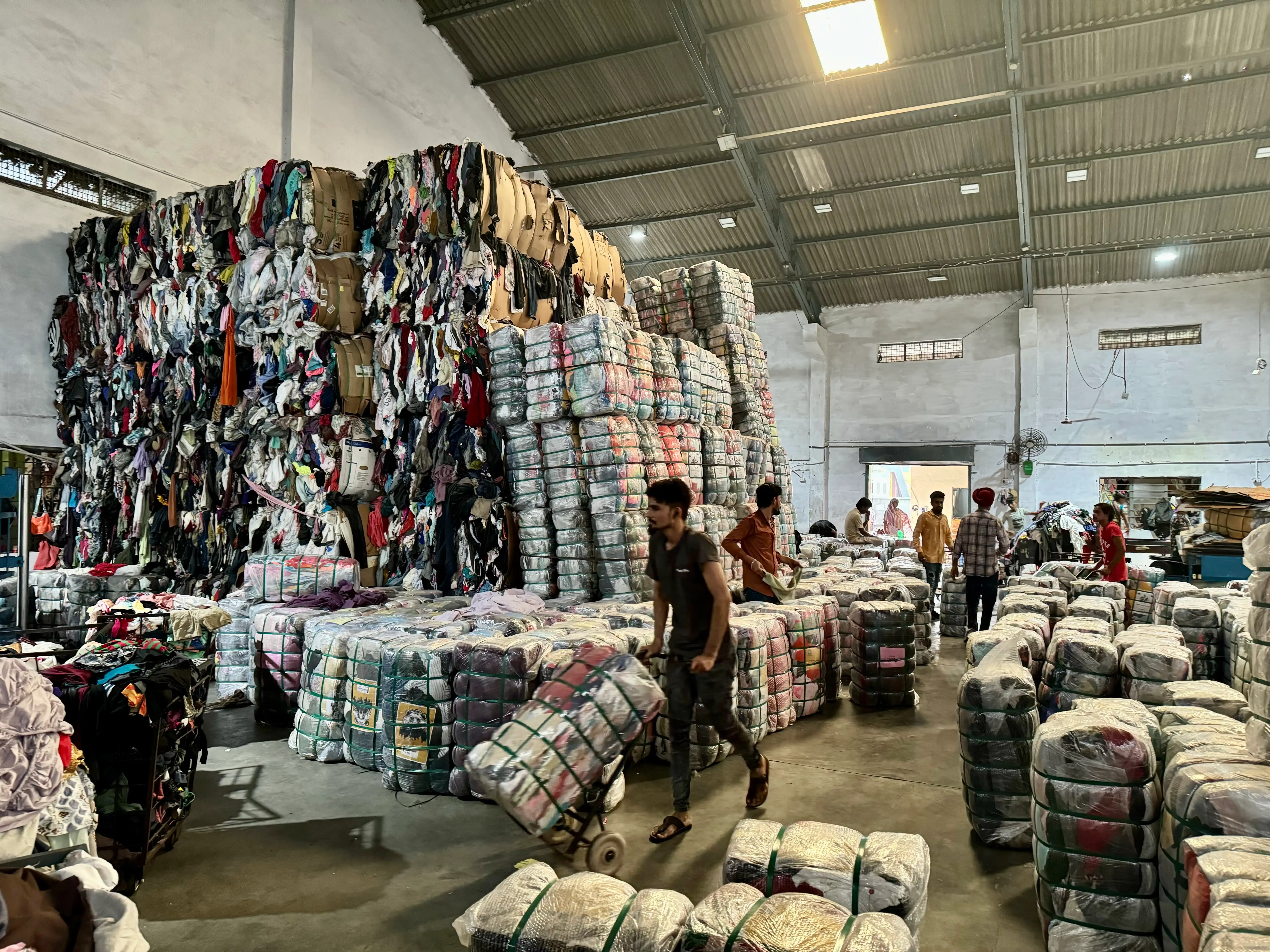 Big bales of used clothing packed and stocked ready to ship.